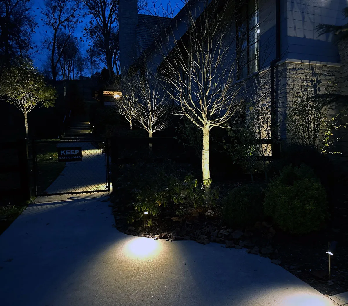 path lighting and uprights accent a residential landscape's outdoor spaces.