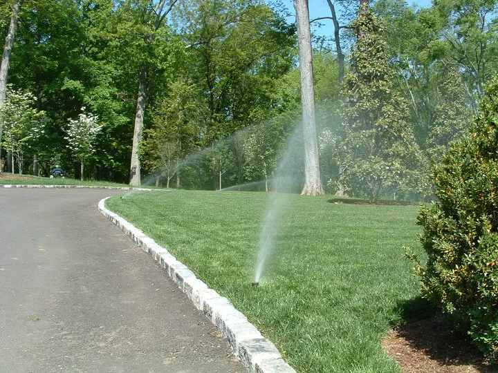 Irrigation system sprinklers watering grass